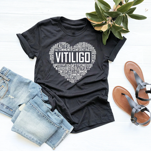 Black tee with "Vitiligo" text in heart shape