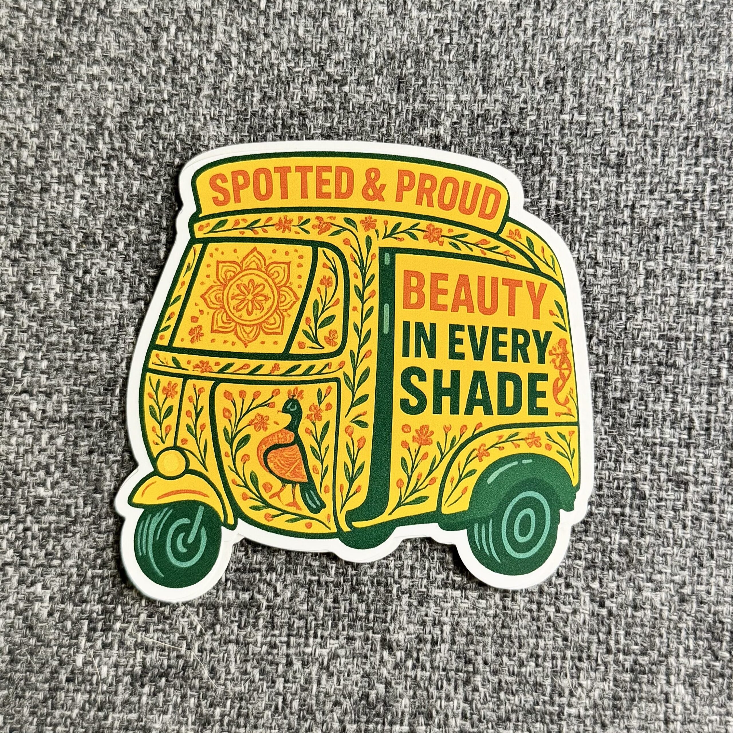 Sticker with the text "Spotted & Proud. Beauty in Every Shade."